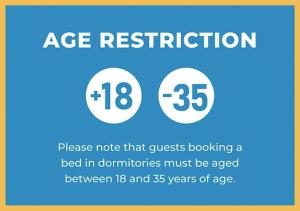 a sign that says age restriction and a bed in donutions must be aged between at Hello Naples in Naples