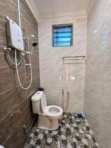a bathroom with a toilet and a shower in it at Fiqthya Chalet & Cafe in Tioman Island