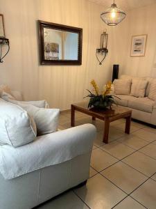 a living room with a couch and a table at Casa en Residencial Privado Lomas de San Francisco in San Salvador