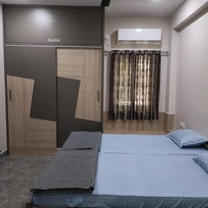 a bedroom with two beds and a window in it at Sukrithi Premium Serviced Apartment - F2 in Chennai