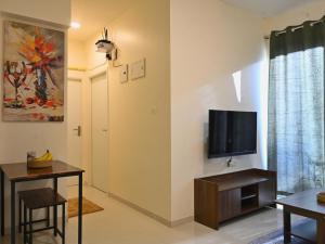 a living room with a flat screen tv on a wall at No Fixed Address in Marmagao