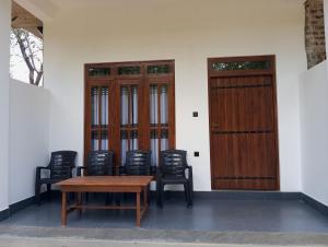 a group of chairs and a table and some doors at River Nature Park in Polonnaruwa