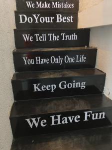 a set of stairs with the words we make mistakes do your best we tell at Rest Inn Hostel Dormitory in Mumbai