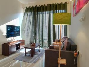 a living room with a couch and a table at No Fixed Address in Marmagao