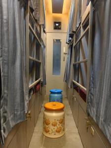 a bathroom with a toilet in a room with stalls at Rest Inn Hostel Dormitory in Mumbai