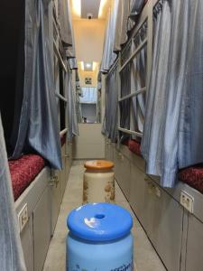 two toilets sitting in a hallway in a vehicle at Rest Inn Hostel Dormitory in Mumbai