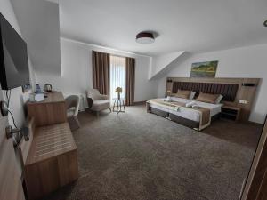a hotel room with a bed and a living room at Evelin Deluxe House in Plovdiv