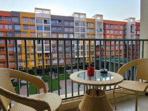 a balcony with a table and chairs and a view of a building at No Fixed Address in Marmagao