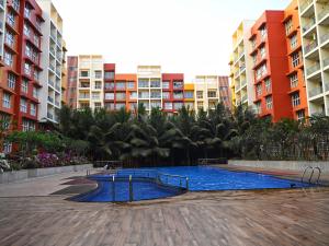 a swimming pool in front of some apartment buildings at No Fixed Address in Marmagao