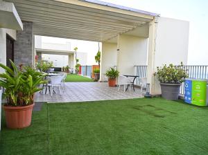 a patio with a table and chairs and plants at No Fixed Address in Marmagao