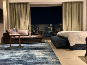 a hotel room with a bed and a couch at Luxury Studios Key 10 in Gurgaon