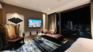 a hotel room with a bed and a couch and a chair at Luxury Studios Key 10 in Gurgaon
