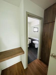 a bathroom with a toilet and a sink at Malada in Chiang Mai