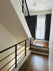 a staircase in a house with a stair railing at Malada in Chiang Mai