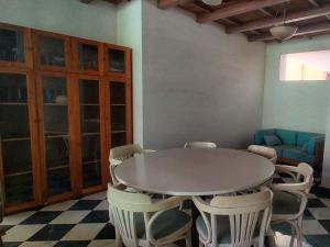 a dining room with a table and chairs at No Fixed Address in Marmagao