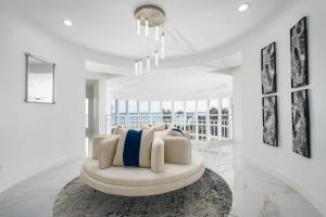 a white living room with a white couch at 9000 SF Waterfront Mansion Pool Boat Dock Theater in Fort Pierce
