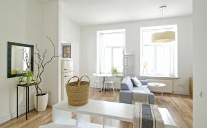 a white living room with a couch and a table at White Door Apartments Heart of Odessa 1 in Odesa +27 photos