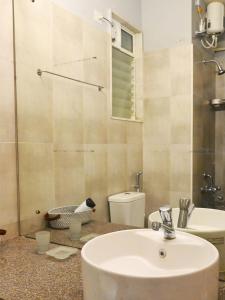 a bathroom with a sink and a toilet at No Fixed Address in Marmagao