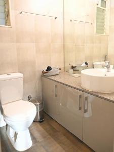 a bathroom with a toilet and a sink at No Fixed Address in Marmagao