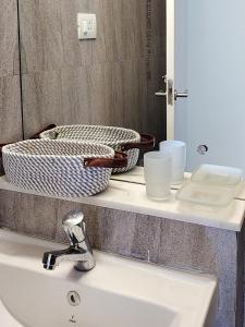 a bathroom sink with a basket on a counter at No Fixed Address in Marmagao