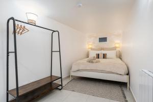 a small bedroom with a bed and a mirror at Le Cocon Traboule & SPA in Lyon