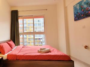 a bedroom with a red bed and a window at No Fixed Address in Marmagao