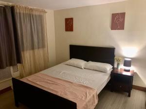 a bedroom with a large bed and a window at TraveLodge in Cainta