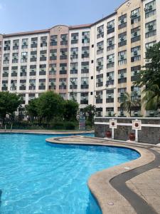 a swimming pool in front of a large building at TraveLodge in Cainta