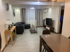 a living room with a couch and a tv at TraveLodge in Cainta