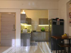 a large kitchen with a refrigerator and a table at No Fixed Address in Marmagao