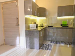a kitchen with a counter with a microwave on it at No Fixed Address in Marmagao