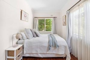 Postel nebo postele na pokoji v ubytování Capital Cottage