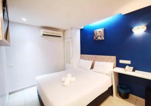 a small room with a bed with a cross on it at Mozu Hotel Sri Hartamas in Kuala Lumpur