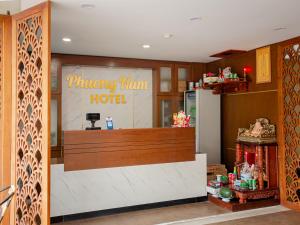 aoking man hotel with a counter in a room at Phuong Nam Luxury Hotel Long Bien in Hanoi