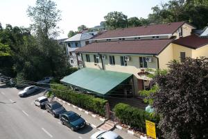 a house with a green awning in front of a street at CASA PHOENIX in Eforie Nord