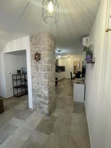 a living room with a stone fireplace in a house at TRE SORELLE in Piran