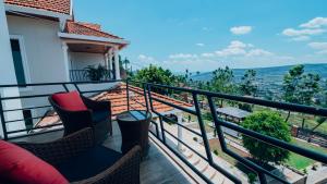 a balcony with two chairs and a view of the city at ROOFTOP VIEW APARTMENTS REBERO in Kigali