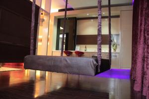 a swing in a living room with purple lighting at Madrid Classic Hotel in Hsinchu City