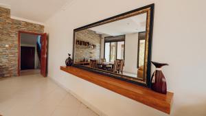 a large mirror on the wall of a living room at ROOFTOP VIEW APARTMENTS REBERO in Kigali