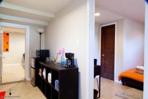 a living room with a television and a room at 1BR Oasis near Takoma Metro Minutes to Capital in Washington, D.C.