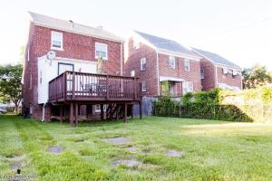 a large brick building with a deck in the yard at 1BR Oasis near Takoma Metro Minutes to Capital in Washington, D.C. +6 photos