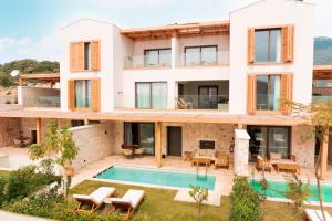 an external view of a house with a swimming pool at Novva Hotels Kas in Kaş
