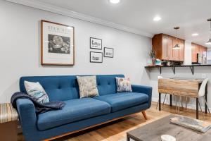 a blue couch in a living room with a table at Entire 1-BR Apt in NoMa Eckington in Washington, D.C.