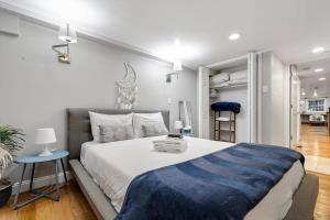 a bedroom with a large bed with a blue blanket on it at Entire 1-BR Apt in NoMa Eckington in Washington, D.C.