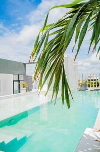 a view of a swimming pool with blue water at Joya de la Zazil 20 Av ROOFTOP POOL Walk to Playa Mamitas Coco Beach & 5 in Playa del Carmen