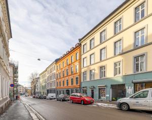 a row of buildings on a street with parked cars at Beautiful space with balcony in Oslo