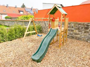 a playground with a slide and a swing set at Alte Försterei 2.0 in Thale