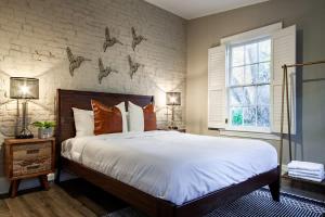 a bedroom with a large bed and a brick wall at IDEAL GEORGETOWN STAY \ PARKING! \ W/D in Washington, D.C.