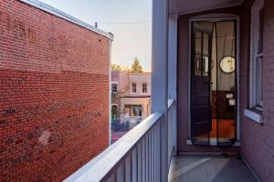 a brick building with a black door on a balcony at IDEAL GEORGETOWN STAY \ PARKING! \ W/D in Washington, D.C.