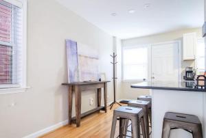 a kitchen with a counter and stools in a room at Transit-Friendly Home Old Town Parking in Alexandria